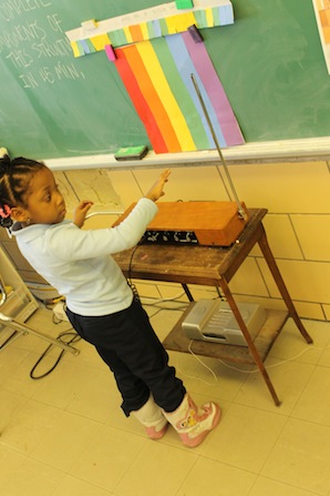 child playing theremin in class